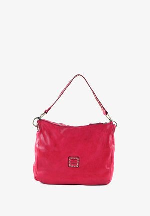 Sac à bandoulière en cuir rose avec une surface texturée, une fermeture éclair sur le dessus et un patch décoratif carré avec des clous métalliques sur le devant.