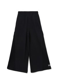 Pantalons larges noirs en tissu doux, dotés d'une taille élastique et de poches latérales, avec une petite étiquette logo sur le bas de la jambe.