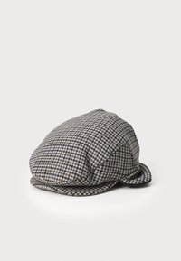 Uld houndstooth-kappe i sort, hvid og brun. Rund form med en let stiv skygge og sideknapper. Tekstureret stof.