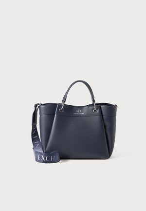 Navy blue textured leather handbag with dual handles, detachable branded shoulder strap, and silver tone hardware.