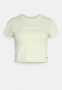 Lys gul cropped t-shirt lavet af bomuld. Har en rund halsudskæring og korte ærmer. Hvid "LEVI'S" logo trykt på forsiden.