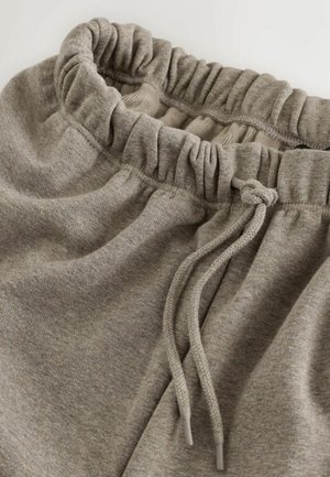 Hallid hallid puuvillased spordipüksid, millel on elastne vöökoht klosetiga tekstuuriga ja reguleeritav pael. Sile ja pehme kangas.