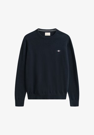 Marineblauwe trui met ronde hals, gemaakt van zacht materiaal, voorzien van lange mouwen en een klein geborduurd logo op de linkerborst.