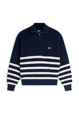 Jersey de punto azul marino con rayas horizontales blancas en el cuerpo y las mangas, cuello con cremallera hasta un cuarto, y pequeño logo rectangular en el pecho.