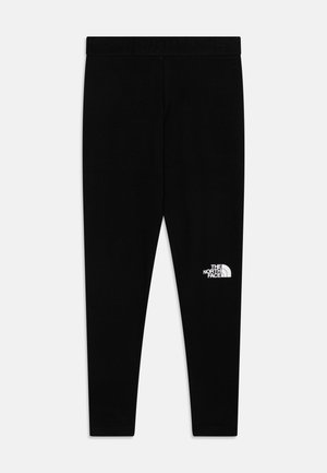 Leggings noirs en matériau doux avec un design ajusté. Présentent une large ceinture élastique et un logo blanc sur la jambe inférieure gauche.