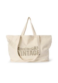 Didelė smėlio spalvos medvilninė rankinė su dviem tvirtais rankenomis. Vienoje pusėje ryškūs, grafiški pilki žodžiai „AMERICAN VINTAGE“.