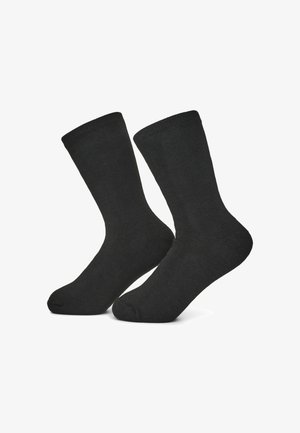 Calze in cotone nere con bordino a costine. Lunghezza a metà polpaccio, texture liscia e design della punta senza cuciture. Adatte per abbigliamento casual e formale.