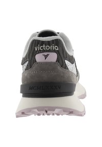 Rear view of gray sneaker featuring a textured upper, silver accents, purple branding, and a white sole with a patterned tread.