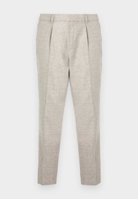 Ljust beige byxor i en strukturerad vävd textil, med en slät framsida, avsmalnande ben och två framfickor. Enkel design utan utsmyckningar.