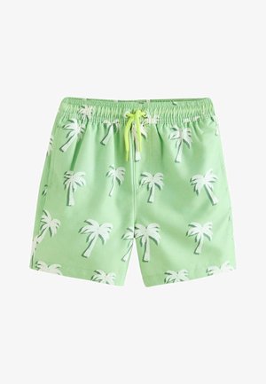 Lysegrønne badeshorts lavet af stof med hvide palmebladstryk, elastisk talje med snøring og glat tekstur.