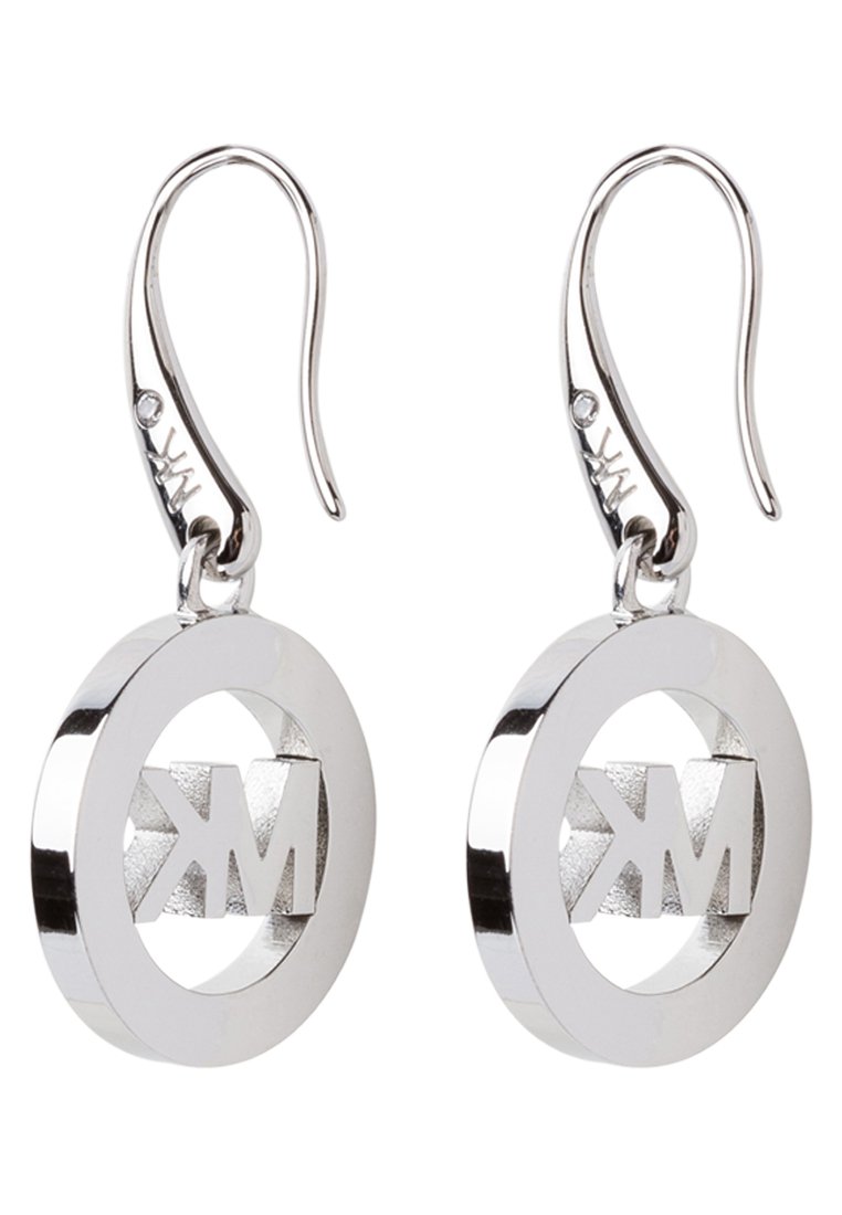 Silberne Creolen haben ein kreisförmiges Design mit einem eingravierten "MK"-Logo in der Mitte und zeigen eine polierte, reflektierende Oberfläche.