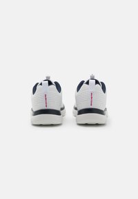 White and navy athletic shoes featuring a breathable mesh upper, rubber sole, rear pull tab, and textured accents for grip.
