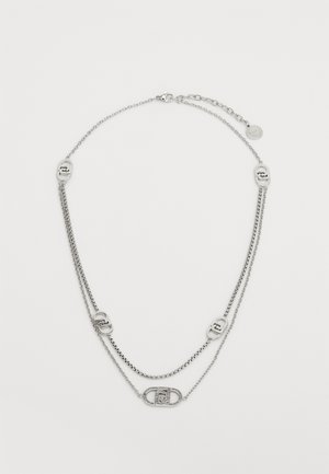 Silver-tone layered necklace featuring chains of varying thickness, oval links, and logo accents. Adjustable clasp at the back.