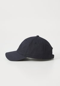 Navy baseball cap made of cotton, featuring a curved brim, six-panel design, adjustable strap at the back, and stitched detailing.
