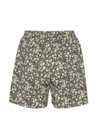 Floral shorts with a black background, featuring white flowers and green leaf accents. Loose fit with an elastic waistband.