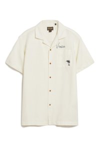 Camicetta a maniche corte color crema con bottoni, dotata di taschino sul petto, con ricamo "Venezia" e un piccolo design di palma.