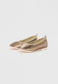 Gylne ballerinasko med en teksturert paljett-overdel, avrundet tå og en myk, lys farge såle, med en liten løftestropp bak.
