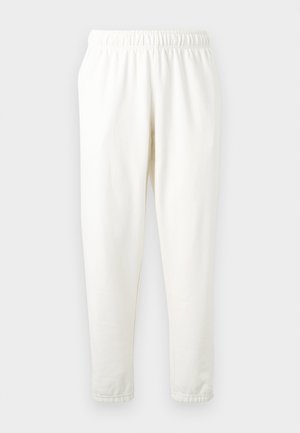 Elastisk-talje cremfargede sweatpants med tapered ben, lavet af blødt materiale. Har en glat overflade og ingen synlige mønstre eller accenter.