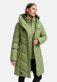 Long green puffer coat with a large hood, chevron stitched design, front zipper closure, and snap buttons. Features side pockets and logo patch.