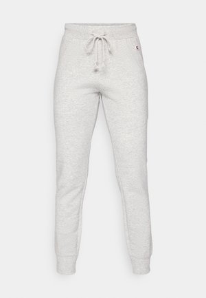 Grå joggebukser laget av myk bomullsblanding, med elastisk midjebånd og snøring samt ribbede mansjetter. Minimal merking på siden.