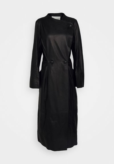 Black leather coat with long sleeves, wrap design, two front buttons, and side pockets. Smooth texture and mid-length silhouette.