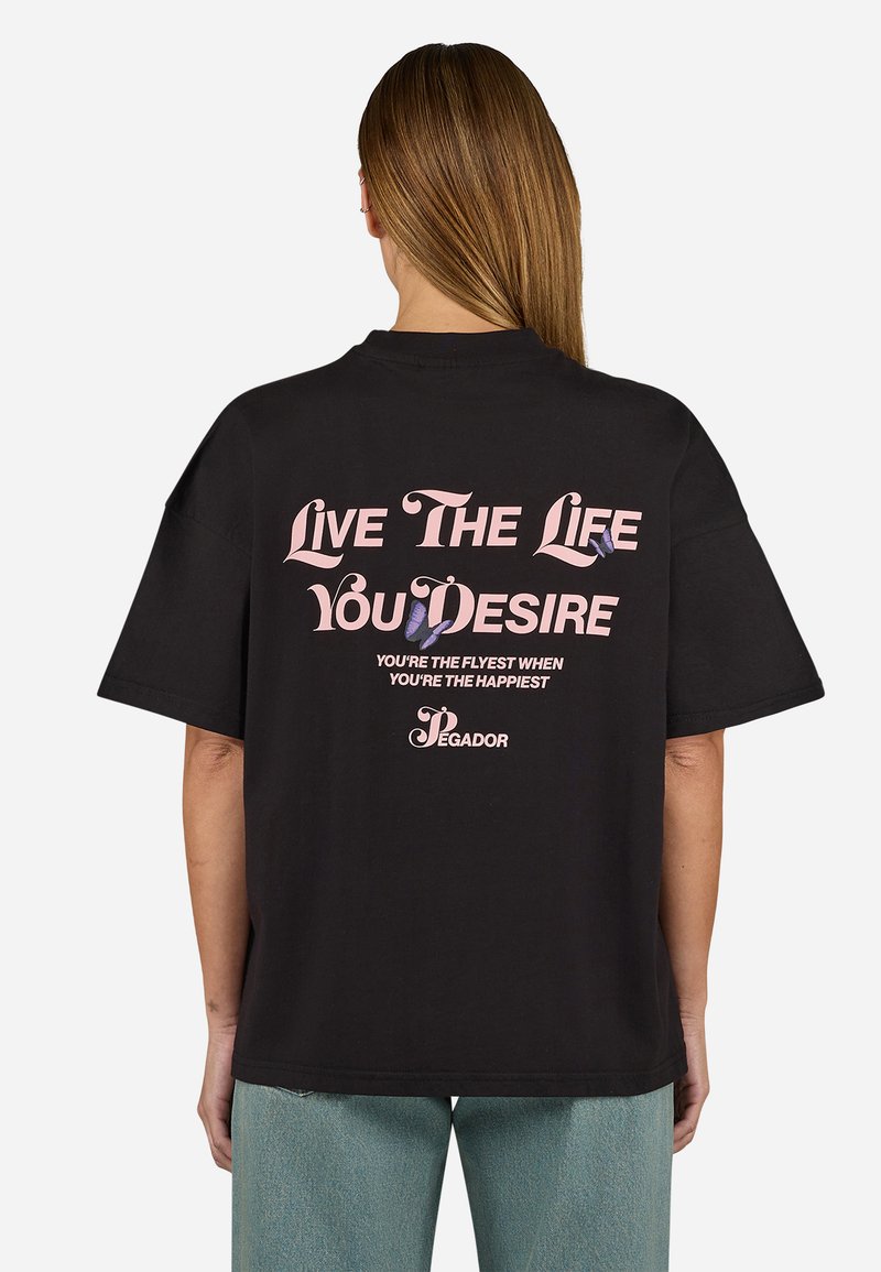 Black cotton T-shirt featuring purple and pink text design on back, with phrases and a butterfly graphic, relaxed fit, short sleeves.