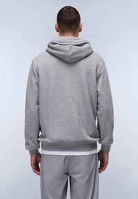 Felpa grigia con cappuccio, realizzata in tessuto morbido, dotata di tasca a marsupio e polsini a costine. Il design è casual con una vestibilità rilassata.