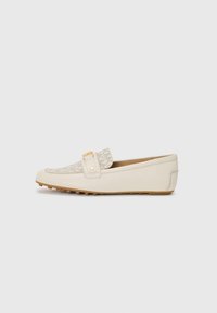 Beige women's loafer with patterned fabric front, gold-tone detail on strap, and rubber sole with grip studs, shown in side profile.