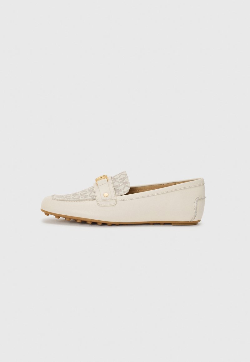Beige women's loafer with patterned fabric front, gold-tone detail on strap, and rubber sole with grip studs, shown in side profile.