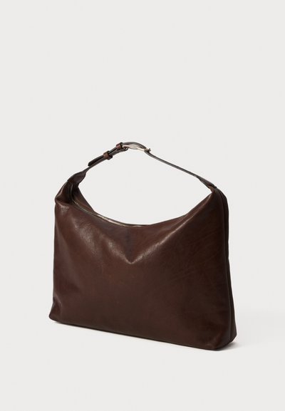 Dark brown leather shoulder bag with a curved top zipper and adjustable strap with metal buckle, displayed against a white background.