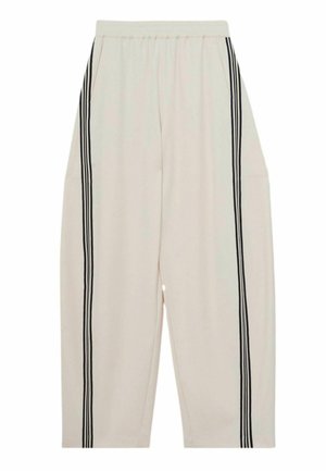 Heledat beežid püksid lõdva lõikega, millel on kaks küljetaskut ja vertikaalsed mustad triibud välissaumadel. Pehme kangas ja elastne vöökoht.