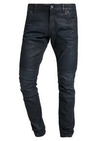 Slim-fit svarta läderbyxor med sydda paneldetaljer och bälteshällor, visade framifrån mot en vit bakgrund.