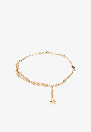Collier chaîne en or avec de petites breloques florales et symboles noires et dorées, comprenant une breloque en forme de cloche dorée suspendue.