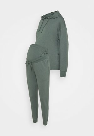 Maternity loungewear set in dark green, featuring a hooded sweatshirt and elastic waist joggers with adjustable drawstring and side seams.