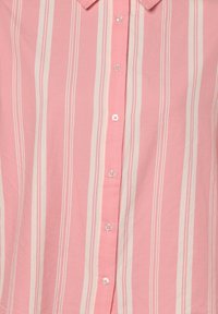 Pink striped button-up shirt with short sleeves, featuring light pink and white vertical stripes and clear plastic buttons.