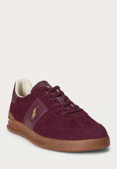 Maroon suede and leather sneaker with brown sole, laces, and gold Polo logo on side, angled view on white background.