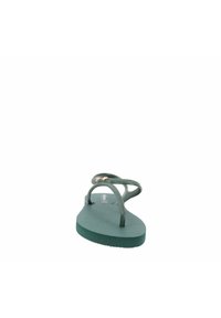 Chanclas de goma verdes con plantilla texturizada, tiras finas y detalle en dorado. Diseñadas para la comodidad, con una suela plana.