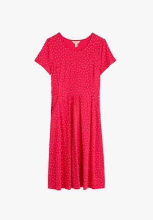 Punainen mekko lyhyillä hihoilla, pyöreällä pääntiellä ja valkoisilla pilkuilla. Varustettu kerrotulla vyötäröllä ja sivutaskuilla, valmistettu hengittävästä kankaasta.