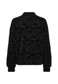 Svart långärmad jacka med ett blommigt sammetsmönster, elastiska ärmslut och en lätt sammetsprydd fåll, sedd bakifrån.