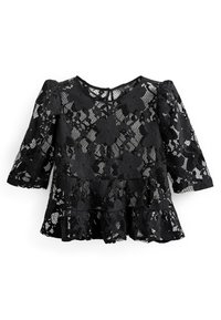 Haut en dentelle noire avec des manches trois-quarts, présentant un design évasé et superposé ainsi que des motifs floraux. Détail en trou de serrure au dos ajoutant un intérêt visuel.