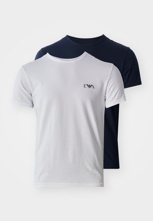 Baumwoll-T-Shirts in Weiß und Marineblau. Kurze Ärmel, Rundhalsausschnitt, mit einem kleinen Logo auf der linken Brust des weißen Shirts. Glatte Textur.