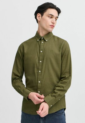 Olive green button-up shirt in a textured fabric, featuring a classic collar, long sleeves, and white buttons along the front.