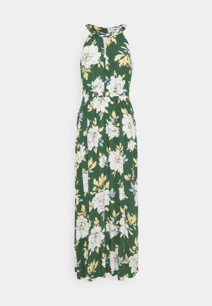 Floral maxi dress in a green fabric. Features white and yellow flowers, a halter neckline, and an elastic waist for a relaxed fit.