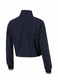 Chaqueta cortada azul marino con cuello alzado, puños de rayas blancas acanaladas y una textura suave que presenta un logo sutil en la parte trasera.