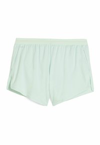 Shorts de sport vert menthe en tissu en maille respirante, dotés d'une coupe décontractée, d'une taille élastique et d'une fente latérale pour la mobilité.