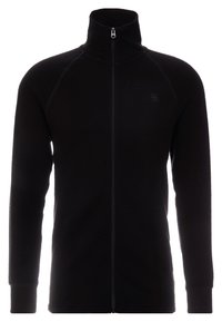 Chaqueta negra con cremallera y cuello alzado, con textura acanalada, mangas largas y un pequeño logotipo en el pecho. Tejido suave, diseño moderno.