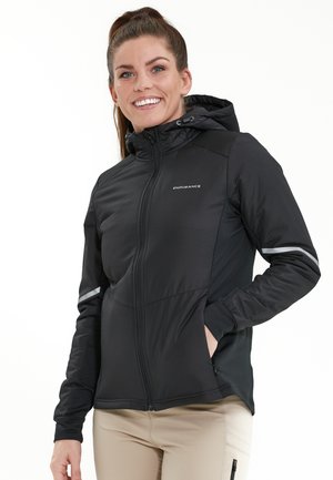 Black hooded jacket with zip closure, made of a smooth, lightweight fabric. Features reflective accents and a fitted design.