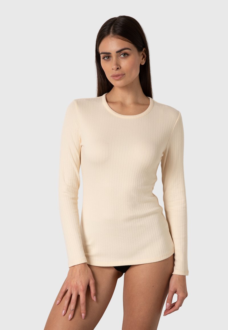 Maglietta a maniche lunghe beige a coste con scollo rotondo. Tessuto morbido, design aderente e sottili linee verticali che creano un aspetto slanciato.