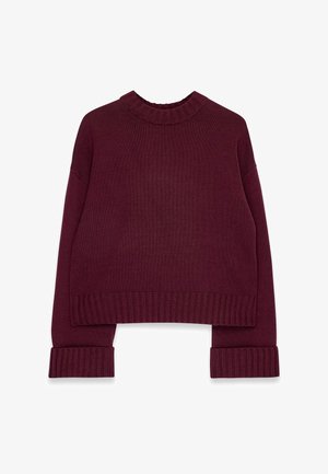 Burgundijas adīta džemperis ar apaļu kaklu, īsu dizainu un ribotām piedurknēm. Izgatavots no mīkstas auduma ar teksturētu apdari.