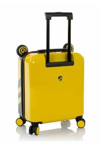 Valigia gialla con guscio rigido e dettagli neri, manico estensibile e quattro ruote. Presenta dettagli circolari a forma di orecchie sulla parte superiore.